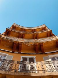 Low angle view of building against clear blue sky