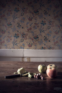 Fruits on table against wall