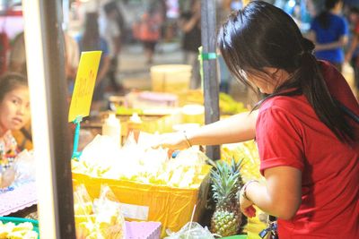 Side view of woman looking at market stall