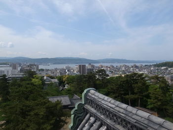 High angle view of buildings in city against sky