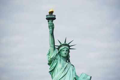 Low angle view of statue of liberty against sky