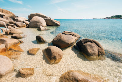 Rocks on beach against sky