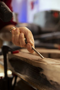 Cropped hand of man working at workshop