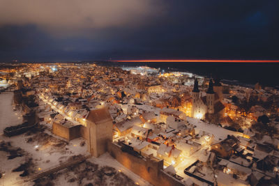 High angle view of illuminated buildings in city at night