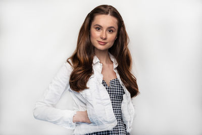 Portrait of a smiling young woman against white background