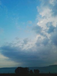 Low angle view of silhouette trees against sky