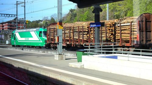 Railroad track in city against clear sky