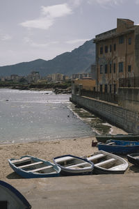 Scenic view of sea by city against sky