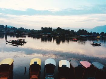 Boats moored in lake against sky