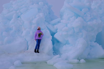 Full length of woman standing on snow