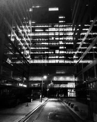 Illuminated tunnel at night