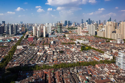 Aerial view of modern buildings in city against sky