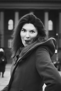 Close up amazed woman in stylish coat on street monochrome portrait picture