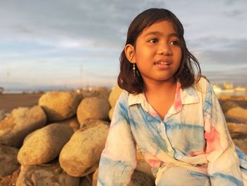 Portrait of girl against sky