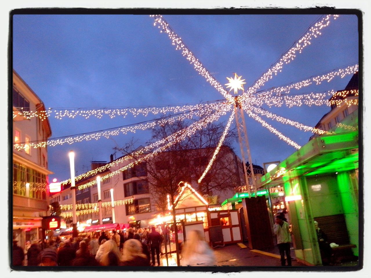 transfer print, illuminated, auto post production filter, night, arts culture and entertainment, sky, leisure activity, lifestyles, large group of people, enjoyment, built structure, amusement park, men, architecture, building exterior, person, amusement park ride, fun, city life