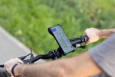 Midsection of man holding mobile phone