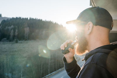 Portrait of young man holding e-cigarette