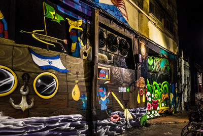Graffiti on wall of building at night