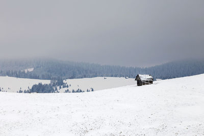 Ski lift on snow field against sky