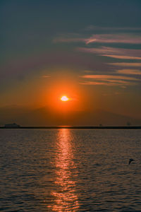 Scenic view of sea against romantic sky at sunset