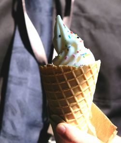 Close-up of hand holding ice cream cone