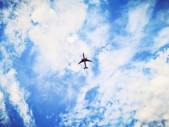 Low angle view of airplane flying in sky