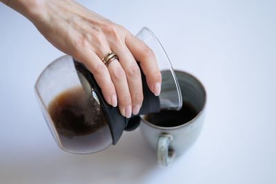 Midsection of woman holding coffee cup