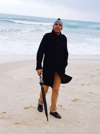 Full length portrait of man walking at beach