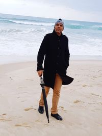 Full length portrait of woman standing on beach