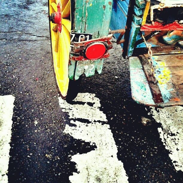 street, transportation, high angle view, yellow, mode of transport, multi colored, sidewalk, road, outdoors, day, low section, wet, land vehicle, water, car, asphalt, umbrella, close-up, puddle, sunlight