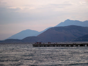 Scenic view of sea and mountains against sky