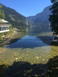 Scenic view of river and mountains against clear sky