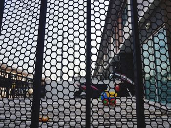 Buildings seen through metal fence