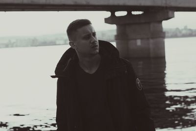 Man looking away while standing in lake