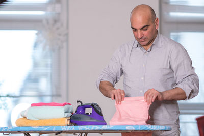 Man holding cloth at home
