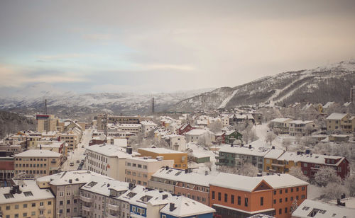 Snow covered narvik against sky