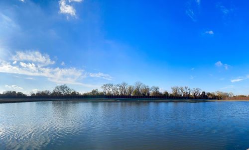 Scenic view of lake against blue sky