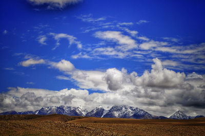 Scenic view of snowcapped mountains against sky