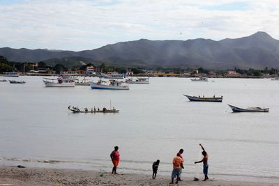 People on beach against sky