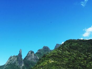 Low angle view of mountain against blue sky