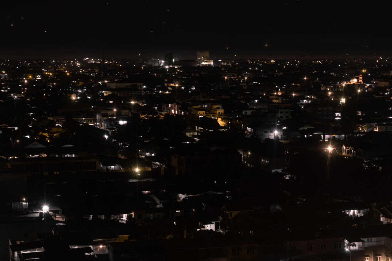 ILLUMINATED CITY BUILDINGS AT NIGHT