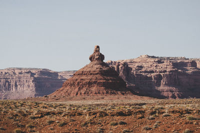 Rock formations on landscape against clear sky