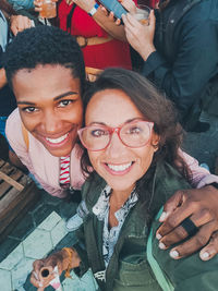 Portrait of smiling friends sitting at home