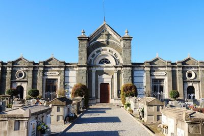 View of ancient buildings against clear blue sky. 