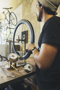 Mechanic working on tire in a custom-made bicycle store