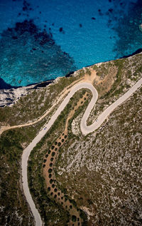 Aerial view of winding road by sea