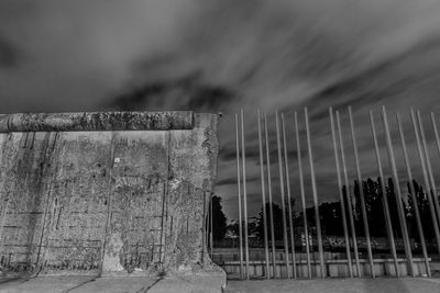 Low angle view of abandoned wall against sky