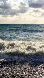 Scenic view of sea against cloudy sky