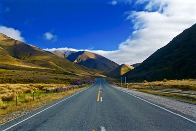 Empty road with mountains in background