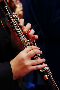 Midsection of person playing flute